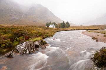 White house near the stream located in Glencoe Valley, in the Scottish Highlands
