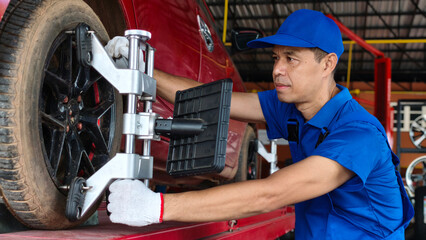 A technician inspects the quality of tires at a large, modern warehouse equipped with forklifts and...