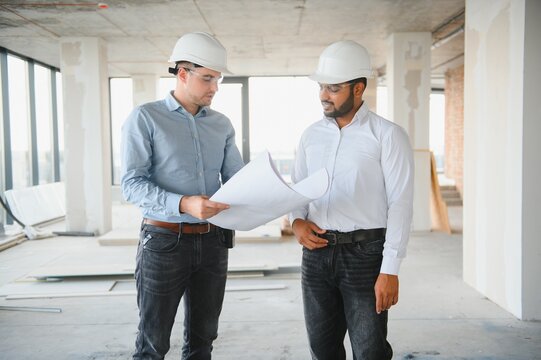 two architect engineers are walking in a constructed office building. implementation of the project