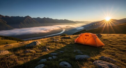 Orange tent in the mountains during a beautiful sunrise