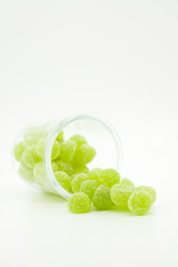 Cannabis thc, cbn, cbd jelly green Gummies, medical drug products. Marijuana infused gummy candies food products portrait format photo on a white background