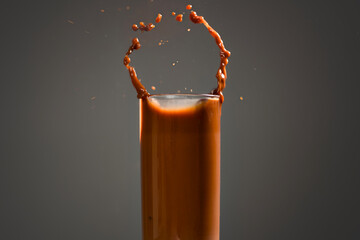 Chocolate splash drink isolated on black background