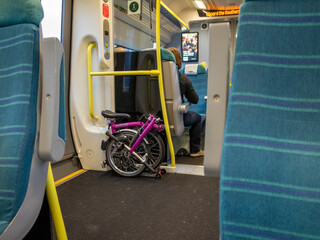 Train interior with folded bike