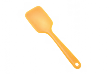 Orange silicone cooking spatula on transparent background, kitchen utensil for baking and mixing