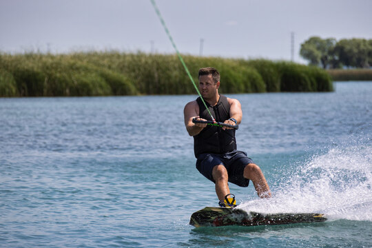A man wakeboarding on a lake