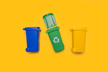 Garbage cans on a yellow background. Flat lay, top view