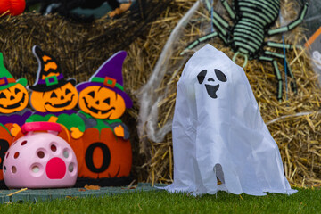 Festive halloween decor scene with Ghost, Spider and
Hay Bales