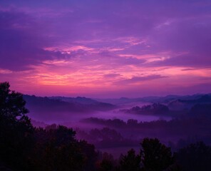Obraz premium Purple sunrise over misty valley