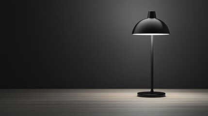 Modern black table lamp casting soft light in a minimalist workspace setting