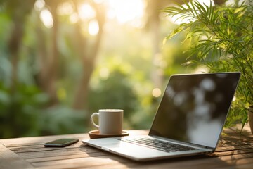 Fototapeta premium Remote work setup: laptop, coffee, phone on wood table, morning sun.