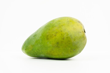 Single green mango sits horizontally isolated on a white background ready for tropical consumption.