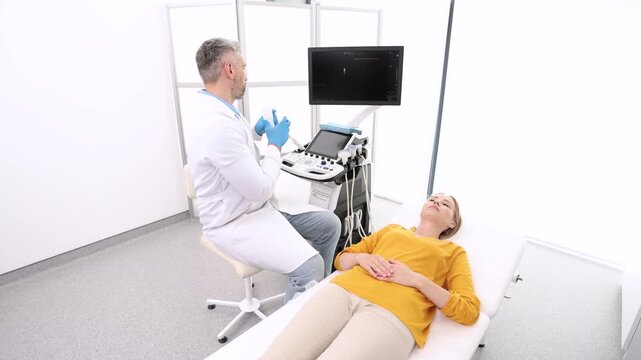 Woman patient receives thyroid diagnostics. Treatment of thyrotoxicosis, and hypothyroidism. Ultrasound diagnostics of endocrine system and thyroid