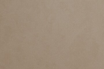 A uniform, light brown-beige textured background, showing subtle wrinkles and variations across its surface, suitable for a minimalist aesthetic