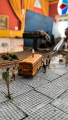 Detailed posaocaliptic zombie miniature urban diorama with school bus, pedestrians, and train tracks creating a realistic small-scale city scene