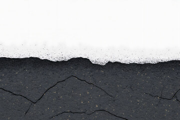 Obraz premium Abstract textured landscape with dark tones and cracks, suggesting erosion and a stark horizon.