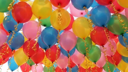 A vibrant and colorful collection of helium balloons floating upwards, creating a festive and celebratory atmosphere - Powered by Adobe