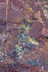 Rugged rock formations dominate the landscape in this outdoor scene. Textured surfaces and earthy tones showcase nature's beauty during the daytime.