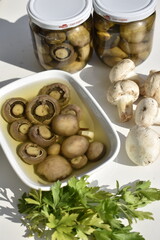 Marinated Mushrooms in a Bowl on White Background Top View