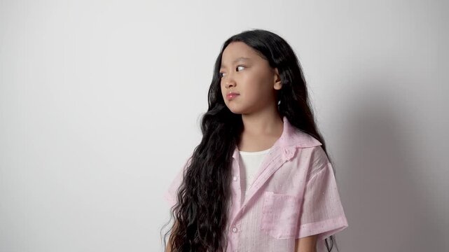 The girl is making a face that shows displeasure or disgust