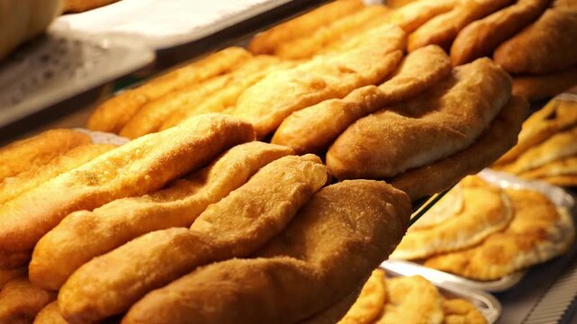 Lots of fried chebureks on the counter in the dining room or on the buffet. The concept of catering and takeaway food.