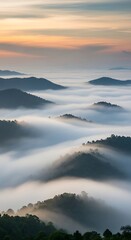 Obraz premium Sunrise over the misty mountain range, a breathtaking landscape view.