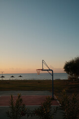 Basketball hoop by the sea at sunrise © Aleksei