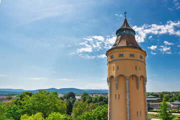 Historic watertower stands tall in Rastatt, Germany under a bright blue sky