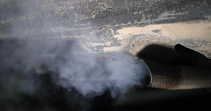 gray harmful smoke from the muffler of an old car with an inoperable or not installed filter for cleaning exhaust gases