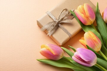 Fresh Tulips Next to a Beautifully Wrapped Gift on a Soft Pastel Background