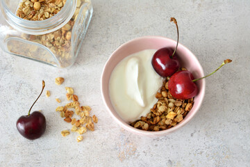 Healthy Yogurt Bowl with Granola and Fresh Cherries flat lay