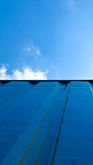 Blue Shipping Container with Sky Background