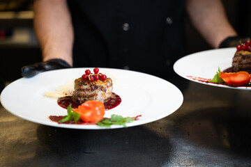 Gourmet Meat Medallion with Red Currants on White Plate