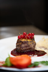 Grilled Meat Fillet with Berry Sauce and Tomato Rose