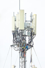 engineer work on gray communication tower