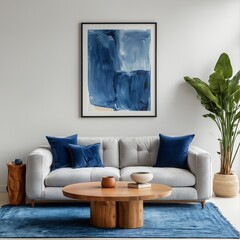a minimalist living room features a light gray sofa adorned with navy blue velvet pillows, a round wooden coffee table, and a striking abstract painting above, all set on a vibrant blue area rug.