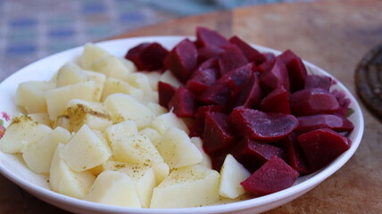 Moroccan beet and potato salad — diced boiled vegetables with cumin and olive oil, colorful...