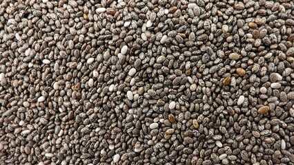 Heap of chia seeds as background, top view. Veggie food. texture
