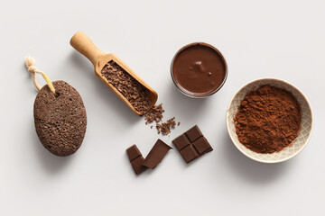 Spa composition with bowls of melted chocolate and cocoa powder on white background