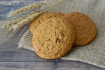 Homemade Oatmeal Cookies with Wheat Stalks on Rustic Burlap