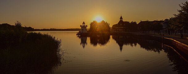 Panoramic photo of the sunset at Lake L'Ailette (Neuville-sur-Ailette, France) with reflections in the water.