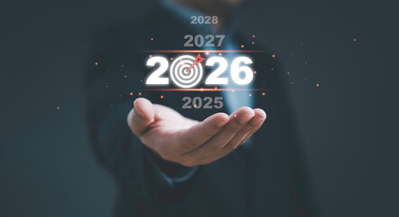 Businessman hand holding 2026 target concept with glowing numbers and future years timeline symbol of business planning goal achievement vision and future success for digital business and strategy