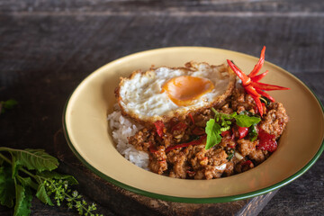 Stir-fried pork with basil and fried egg served in a traditional dish – Authentic Thai street food. Still image