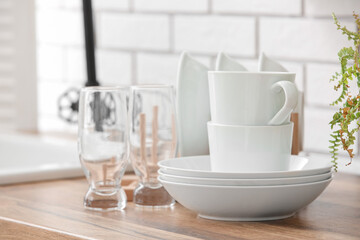 Set of clean tableware on table in kitchen