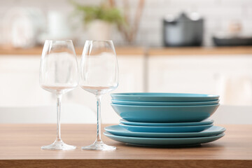 Set of clean dishes on table in kitchen