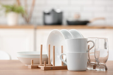 Set of clean tableware on table in kitchen