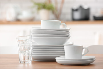Set of clean dishes on table in kitchen
