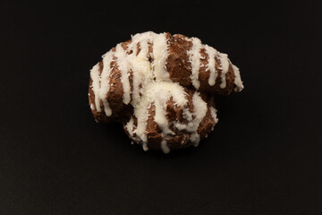 Profiteroles with coconut cream on a black background.