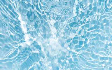 Blue water with ripples on the surface. Defocus blurred transparent blue colored clear calm water surface texture with splashes and bubbles. Water waves with shining pattern texture background.