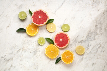 Slices of tasty citrus fruits on marble background