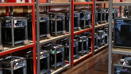 room with a large number of 3D printers, the creation of three-dimensional toys and parts in the...